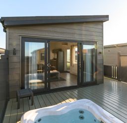 An outdoor area with a hot tub and sliding doors at Grasmere in Penrith