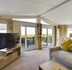 A living room with a television and sliding doors at Keswick in Penrith