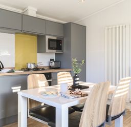 A kitchen with a table and chairs at Grasmere (Pet) Penrith