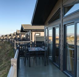 A deck with table and chairs at Keswick (Pet) Penrith