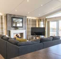 A living room with a sofa and television at Keswick (Pet) Penrith