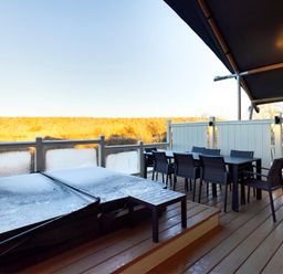 An outdoor area with a hot tub and dining set at Savannah in Penrith