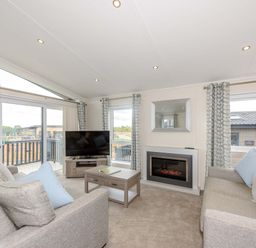 A living room with a television and fireplace at Helvellyn in Penrith