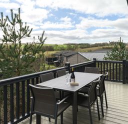 A deck with a table and chairs at Helvellyn (Pet) in Penrith