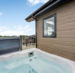 An outdoor area with a hot tub and decking at Helvellyn (Pet) Penrith
