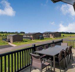 A terrace with a table and chairs at Scaféll (Pet) Penrith