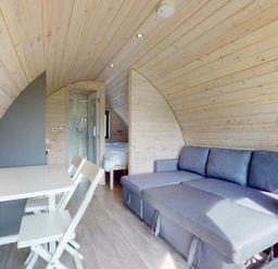 A living room with a sofa and table at Pod 2 (No Pets) in Carnforth