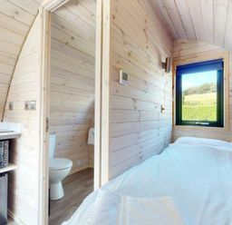 A bedroom with a bed and a microwave at Pod 3 (No Pets) Carnforth