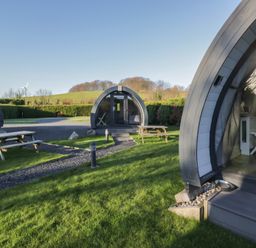 Outdoor area with glamping pods and picnic tables at Pod 6 (No Pets) Tewitfield