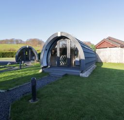 An outdoor area with pods and picnic tables at Pod 7 (Pet Friendly) in Tewitfield