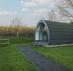 A garden with a pod and a picnic table at Pod 9 (No Pets) Tewitfield near Carnforth