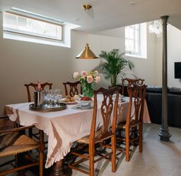 A dining room with a table and chairs at The School House in Newton Abbot