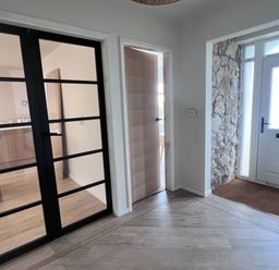 An entrance hall with glass doors and a front door at 81 Lon Gogarth Benllech