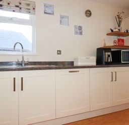 A kitchen with a sink and cabinets at 65 Benasa Lodge in Winnard's Perch near St Columb Major