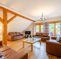 A living room with sofas and a coffee table at Eagle Spa Plus in Dundee
