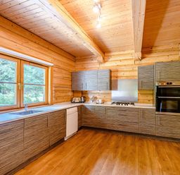 A kitchen with cabinets and appliances at Foresters Spa Plus (Pet) in Dundee