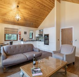 A living room with a sofa and coffee table at Byron Premier Spa (Pet) in Dundee