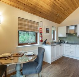 A kitchen with dining area at Byron Premier Spa (Pet) Dundee