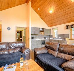 A living room with a sofa and coffee table at Muirloch Spa Plus in Dundee