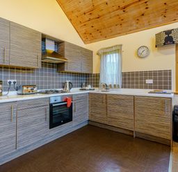 A kitchen with cabinets and appliances at Muirloch Spa Plus (Pet) in Dundee