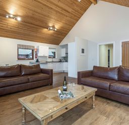 A living room with sofas and a coffee table at Raeburn Premier Spa in Dundee