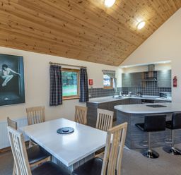 A kitchen with dining table and appliances at Rainbow Spa Plus in Dundee
