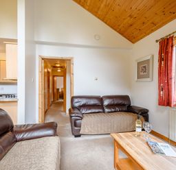 A living room with a sofa and a table at Osprey Lodge in Dundee