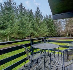 An outdoor area with a table and chairs at Osprey Lodge (Pet) Dundee