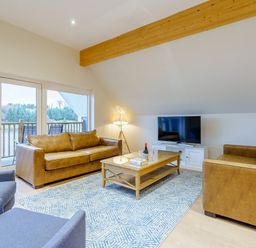 A living room with sofas, a coffee table and a television at Lochside Premier Spa (Pet) in Dundee