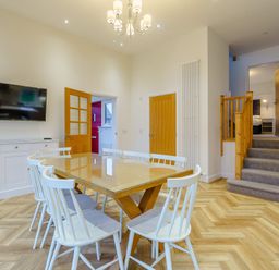 A dining room with a table and chairs at Lochside Premier Spa (Pet) in Dundee