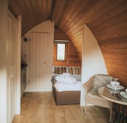 A room with a bed and a table at Garden Pod VIP in Waltham