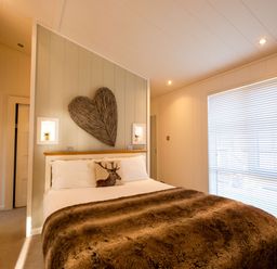 A bedroom with a bed and wall art at The Belfry in Waltham