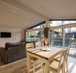 A living room with a dining table and sofa at Belfry in Waltham