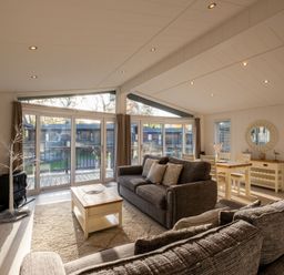 A living room with a sofa and table at Belfry in Waltham