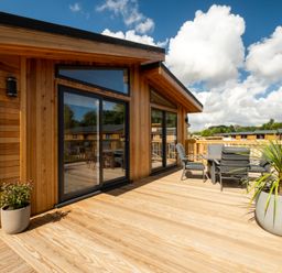 An outdoor deck with seating and plants at Moonlight Spa Luxury Waltham