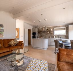A living room with a kitchen island and dining area at Moonlight Spa Luxury in Waltham