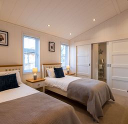 A bedroom with two beds and windows at Wentworth in Waltham