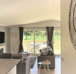 A living room with a television and sofa at Dream View in Waltham