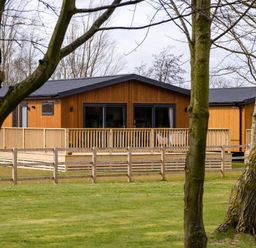 A wooden cabin with a deck at Royal View in Waltham