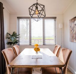 A dining room with a table and chairs at Goldfinch in Waltham