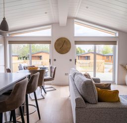 A living room with a sofa and dining area at The Luxury Escape in Waltham