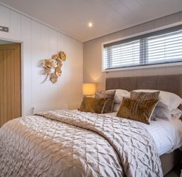 A bedroom with a bed and bedside table at The Luxury Escape in Waltham