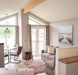 A living room with a sofa and dining table at The Henley in Waltham