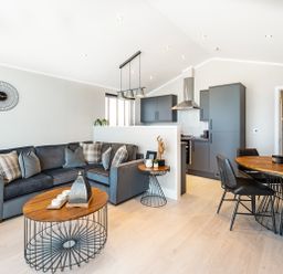 A living room with a sofa and dining area at Shangri-La in Waltham