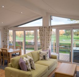 A living room with a sofa and dining area at The Royal in Waltham