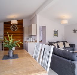 A living room and kitchen area with furniture at The View in Waltham