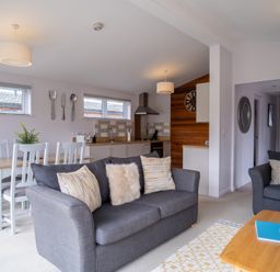 A living room with a sofa and dining area at The View in Waltham