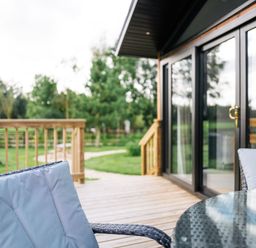 An outdoor space with a table and chairs on the decking at Macosi in Waltham