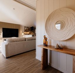 A living room with a sofa and television at Luxury Boutique Retreat Spa in Waltham