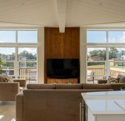 A living room with a television and sofas at Exclusive Aura Spa in Waltham